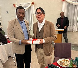 Fr. Francis Folleh, CSSp (former Provincial Superior) presents appreciation award to Fr. Paul McAuley, CSSP at the annual Spiritan Advent dinner, December 11, 2023